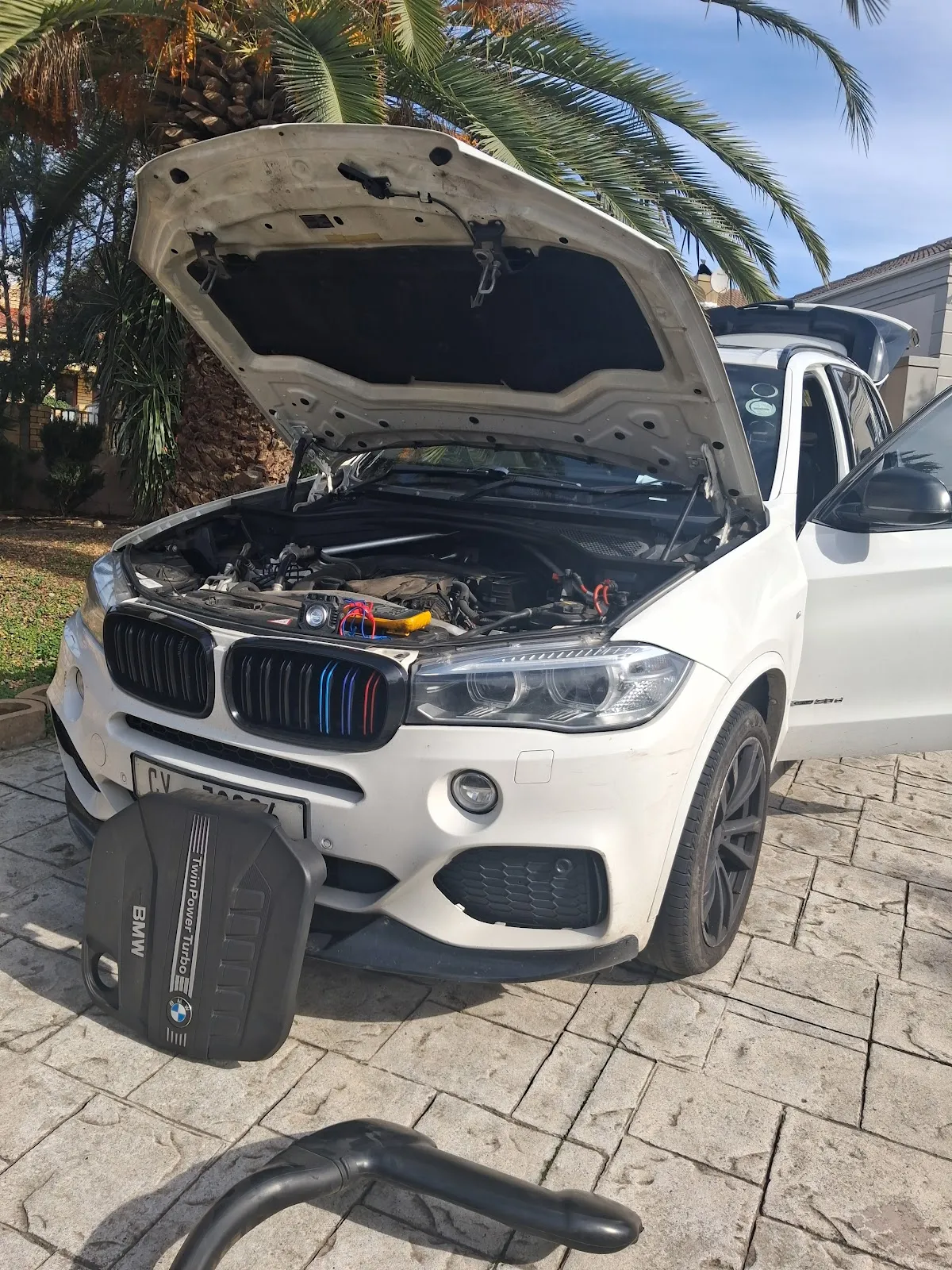 Dayne, our lead mechanic, performing an on-site driveway car service in Cape Town